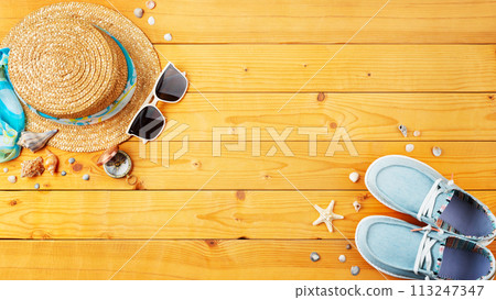 Summer holiday vacation travel planning background of straw hat, sunglasses, moccasins and shells on natural wooden planks Summer holiday vacation travel planning background of straw hat, sunglasses, moccasins and shells on natural wooden planks 113247347