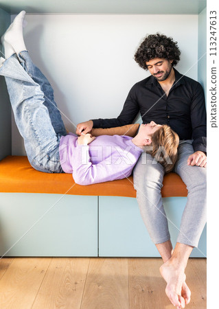 Relaxed Couple Enjoying a Cozy Moment on a Modern Bench at Home 113247613