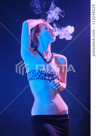 woman blowing smoke 113248229