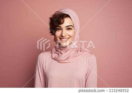 A woman wearing a pink hijab is smiling 113248552