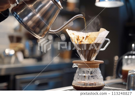 Barista brews drip brewing in a pour-over, close-up of a pour-over with hot water and filter paper, filtered coffee or pour over coffee Barista brews drip brewing in a pour-over, close-up of a pour-over with hot water and filter paper, filtered coffee or pour over coffee 113248827
