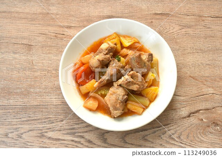 fried mixed vegetable with chop pork bone in sweet and sour gravy sauce on white plate  113249036