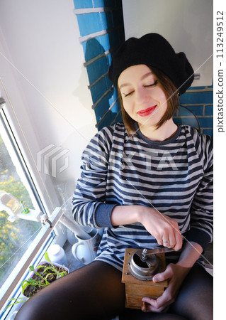 girl grinds coffee girl grinds coffee 113249512