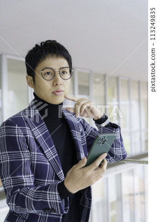 Portrait of a young man wearing glasses, vertical position Photography cooperation: Ariake College of Education and Arts Portrait of a young man wearing glasses, vertical position Photography cooperation: Ariake College of Education and Arts 113249835