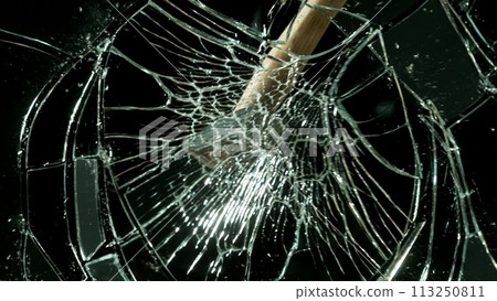 Freeze motion of glass-breaking hammer, shattering against black background Freeze motion of glass-breaking hammer, shattering against black background 113250811
