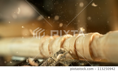 Close-up of carving wood with a chisel. Low depth of focus, super macro shot. 113250942