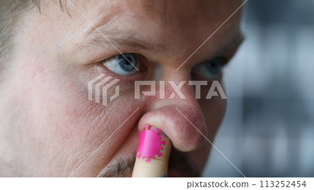 Man put his finger in nose coronavirus germs Man put his finger in nose coronavirus germs 113252454