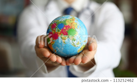 Male doctor hand hold earth with virus symbol closeup. 113252462