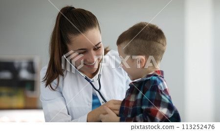 Cheerful specialist talking to kid Cheerful specialist talking to kid 113252476
