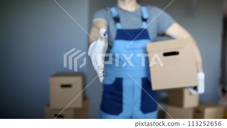 Male hand hold cardboard against new flat closeup Male hand hold cardboard against new flat closeup 113252656