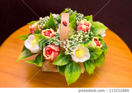 Cute bouquet of handmade soap flowers on a small table Cute bouquet of handmade soap flowers on a small table 113252869