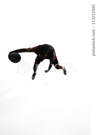 Top view image, silhouette of man, basketball player in motion during game, training, playing isolated on white background Top view image, silhouette of man, basketball player in motion during game, training, playing isolated on white background 113252995