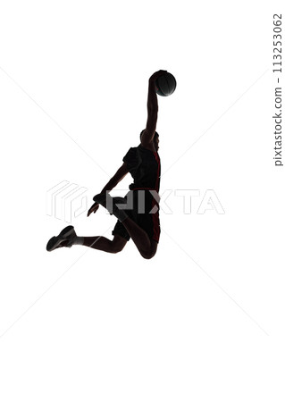 Slam dunk. Back view silhouette of young man, basketball player in motion throwing ball during game isolated on white background 113253062