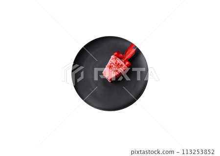 Delicious sweet cheesecake with fruits covered with icing with a wooden stick 113253852