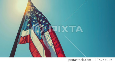 American flag waving against a clear blue sky. American flag waving against a clear blue sky. 113254026