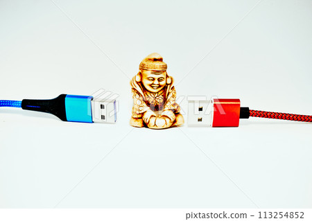 Buddhist monk,modern technology Connect and chat. Red and blue usb cables 113254852