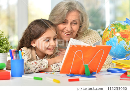 Happy Grandmother with granddaughter drawing together 113255060