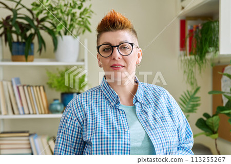 Portrait of smiling middle-aged woman in glasses with red haircut 113255267