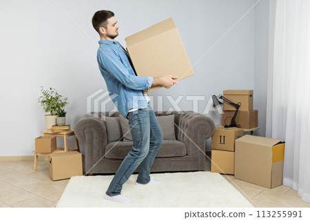 Moving concept, man with boxes in apartment. 113255991