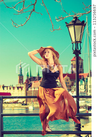Sitting woman wearing big sun hat and elegant dress Sitting woman wearing big sun hat and elegant dress 113256697
