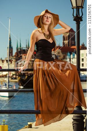 Sitting woman wearing big sun hat and elegant dress Sitting woman wearing big sun hat and elegant dress 113256701
