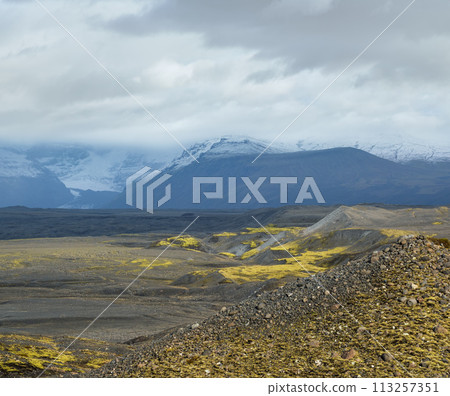 Iceland autumn tundra landscape near Haoldukvisl glacier, Iceland. Glacier tongue slides from the Vatnajokull icecap or Vatna Glacier near subglacial Esjufjoll volcano. Not far from Iceland Ring Road. 113257351