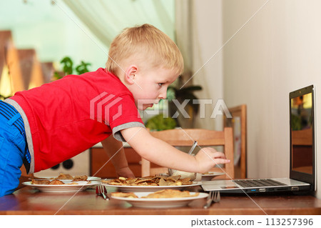 Little boy preparing pancakes for breaktfast Little boy preparing pancakes for breaktfast 113257396
