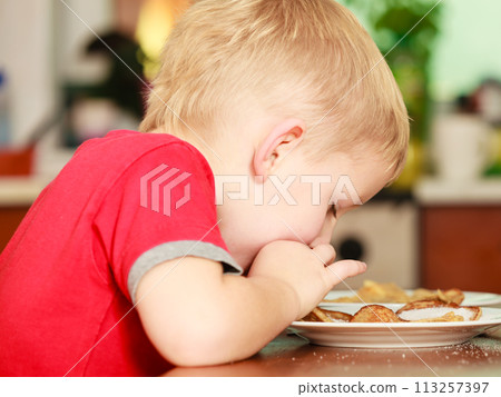 Little boy eating pancakes for breaktfast Little boy eating pancakes for breaktfast 113257397