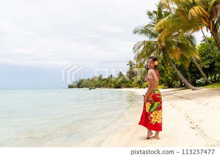 French Polynesia Tahiti luxury travel beach vacation woman walking in sarong on island, French Polynesia. Image is completely unretouched, model has no makeup. Authentic real people. Raw Image French Polynesia Tahiti luxury travel beach vacation woman walking in sarong on island, French Polynesia. Image is completely unretouched, model has no makeup. Authentic real people. Raw Image 113257477