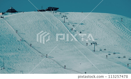 Beautiful Alpine skiing slope and ski lift in the mountains. Alpe d'Huez ski resort, France Beautiful Alpine skiing slope and ski lift in the mountains. Alpe d'Huez ski resort, France 113257478