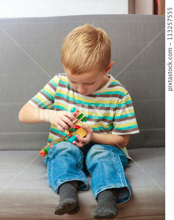 Little boy playing with toys having fun Little boy playing with toys having fun 113257555
