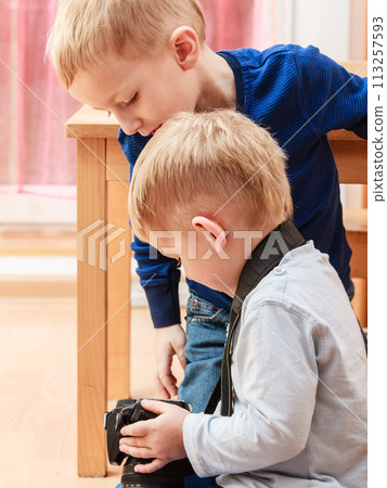 Little boys play with camera. Little boys play with camera. 113257593