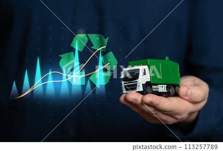 Waste recycling and business. Investing in recycled materials. Environmental projects. A businessman holds a garbage truck in his hand. Conserve natural resources, reduce waste. Generate profit. Waste recycling and business. Investing in recycled materials. Environmental projects. A businessman holds a garbage truck in his hand. Conserve natural resources, reduce waste. Generate profit. 113257789