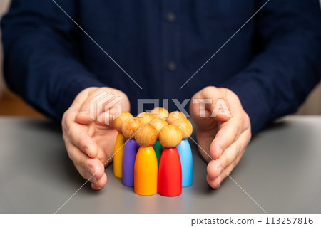 Boss defending his team with a gesture of protection.Security and safety in a business team concept. Life insurance. Customer care, care for employees. Human resources. Social protection. 113257816