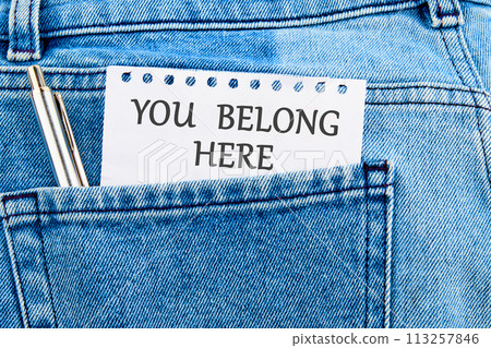 Diversity, business, inclusion and belonging concept. You belong here symbol on a piece of paper that appeared from the pocket of jeans Diversity, business, inclusion and belonging concept. You belong here symbol on a piece of paper that appeared from the pocket of jeans 113257846