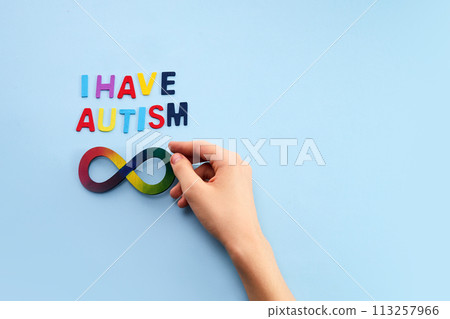 Autistic boy hands and rainbow eight infinity symbol. Autism awareness day symbol. Autistic boy hands and rainbow eight infinity symbol. Autism awareness day symbol. 113257966