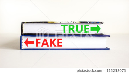 True or fake symbol. Concept word True or Fake on beautiful books. Beautiful white table white background. Business and true or fake concept. Copy space. 113258073