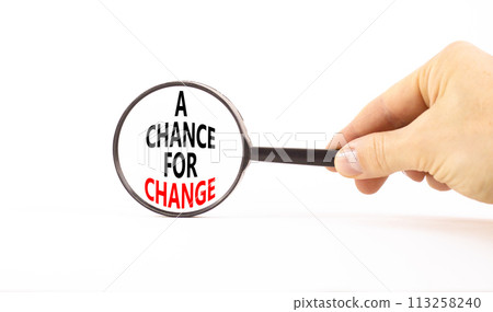 A chance for change symbol. Concept words A chance for change on beautiful magnifying glass. Beautiful white table white background. Voter hand. Business A chance for change concept. Copy space. A chance for change symbol. Concept words A chance for change on beautiful magnifying glass. Beautiful white table white background. Voter hand. Business A chance for change concept. Copy space. 113258240