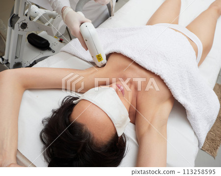 Beautician Removing Hair under armpit Beautician Removing Hair under armpit 113258595