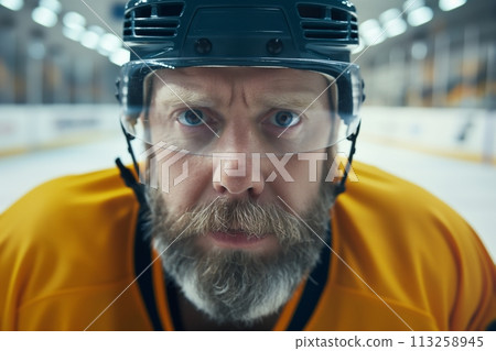 Close up portrait of a professional Ice hockey player wearing yellow uniform 113258945