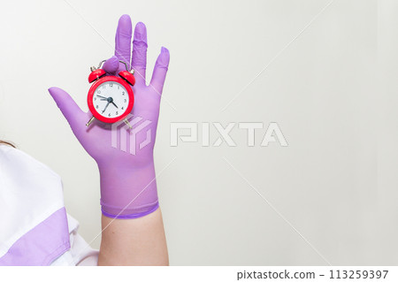 Cropped view of woman holding alarm clock  113259397