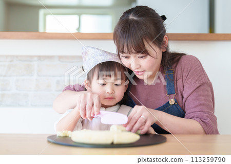 Girl helping her mother cook 113259790
