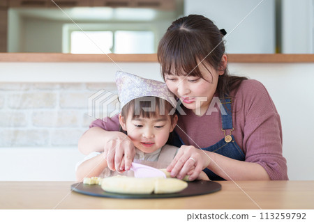 Girl helping her mother cook 113259792