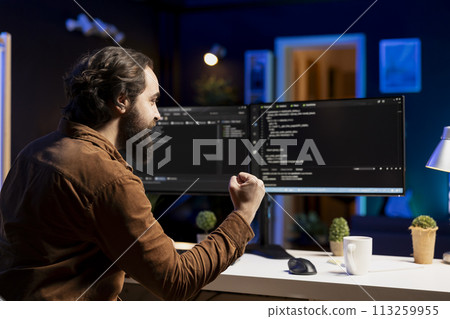 Happy man doing software quality assurance celebrating after reading source code and finding no errors. Cheerful developer excited after inspecting coding on desktop PC, seeing no issues 113259955