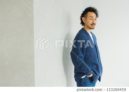 Middle-aged man standing with a smile Middle-aged man standing with a smile 113260459