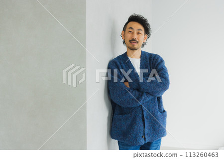 Middle-aged man standing with a smile Middle-aged man standing with a smile 113260463