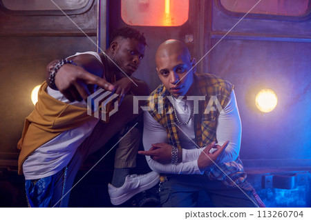 Cool young guys rappers shooting video in misty subway underground Cool young guys rappers shooting video in misty subway underground 113260704