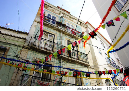 Colorful decorations on whitewashed houses in Lisbon's old town Colorful decorations on whitewashed houses in Lisbon's old town 113260731