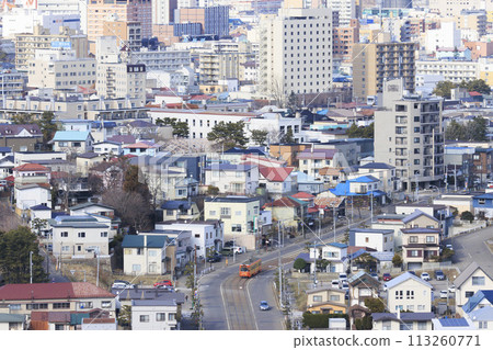 [Logo, number plate, and driver blurred] Orange tram going downhill from Aoyagicho, Hakodate City to Yachigashira 113260771
