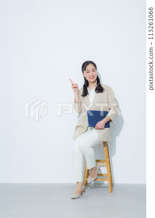 Smiling businesswoman holding a tablet 113261066